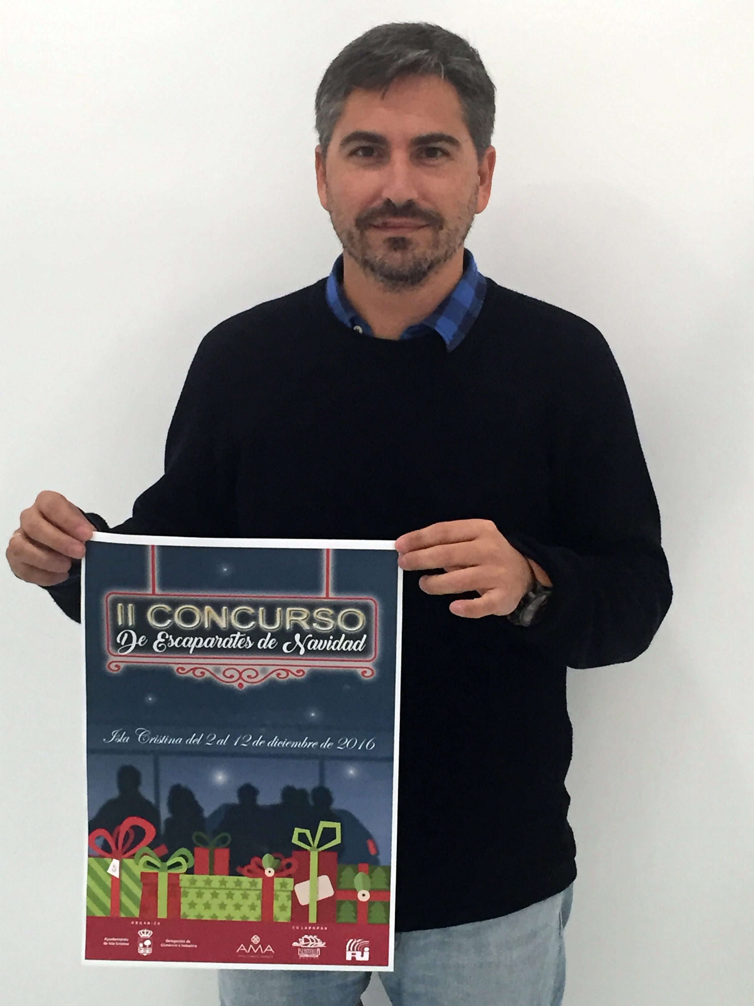 El concejal de Comercio, Carlos Guarch muestra el Cartel del Concurso